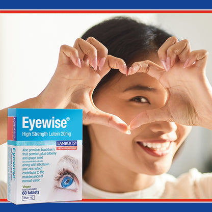 Woman making a heart shape with her hands and an Eyewise supplement box in the foreground.