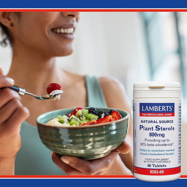 Person eating a bowl of fruit salad with a supplement bottle labeled 'Lambert's' in the foreground.