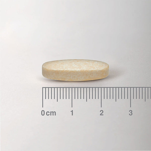 Beige tablet with a ruler for scale on a white background