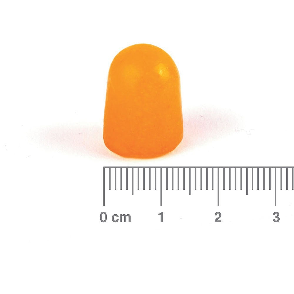 Orange gummy supplement with a ruler for scale on a white background