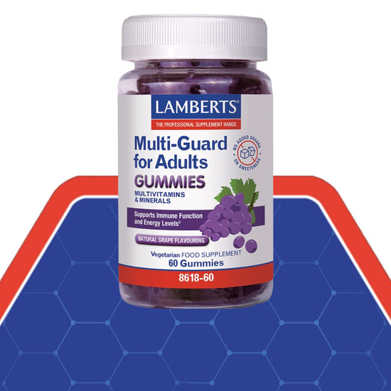 A bottle of Lamberts Multi-Guard for Adults Gummies, featuring a white label with blue and red text, a grape illustration, and a white cap, set against a blue and red graphic background.