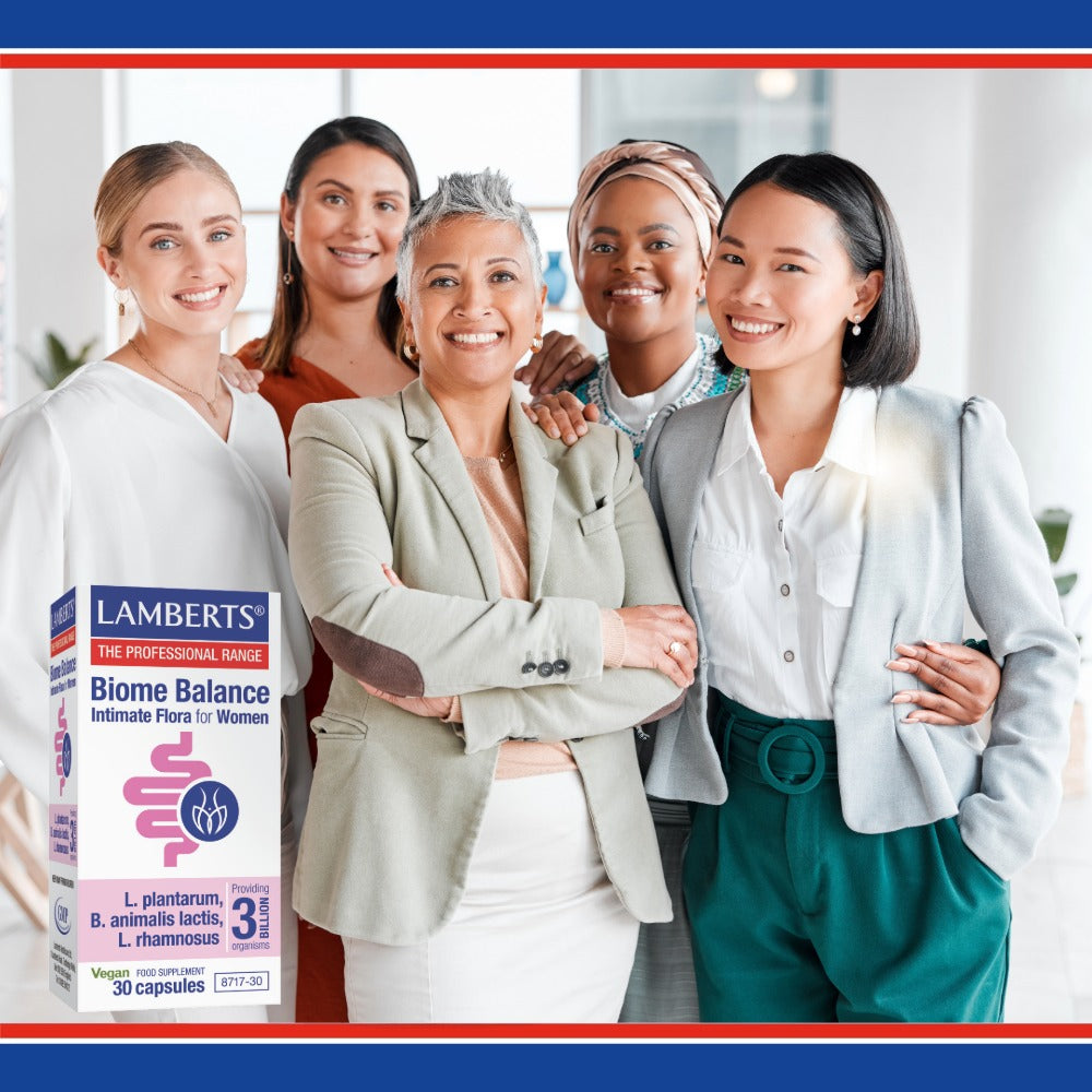 Five women standing together with a Lamberts Biome Balance product in the foreground.