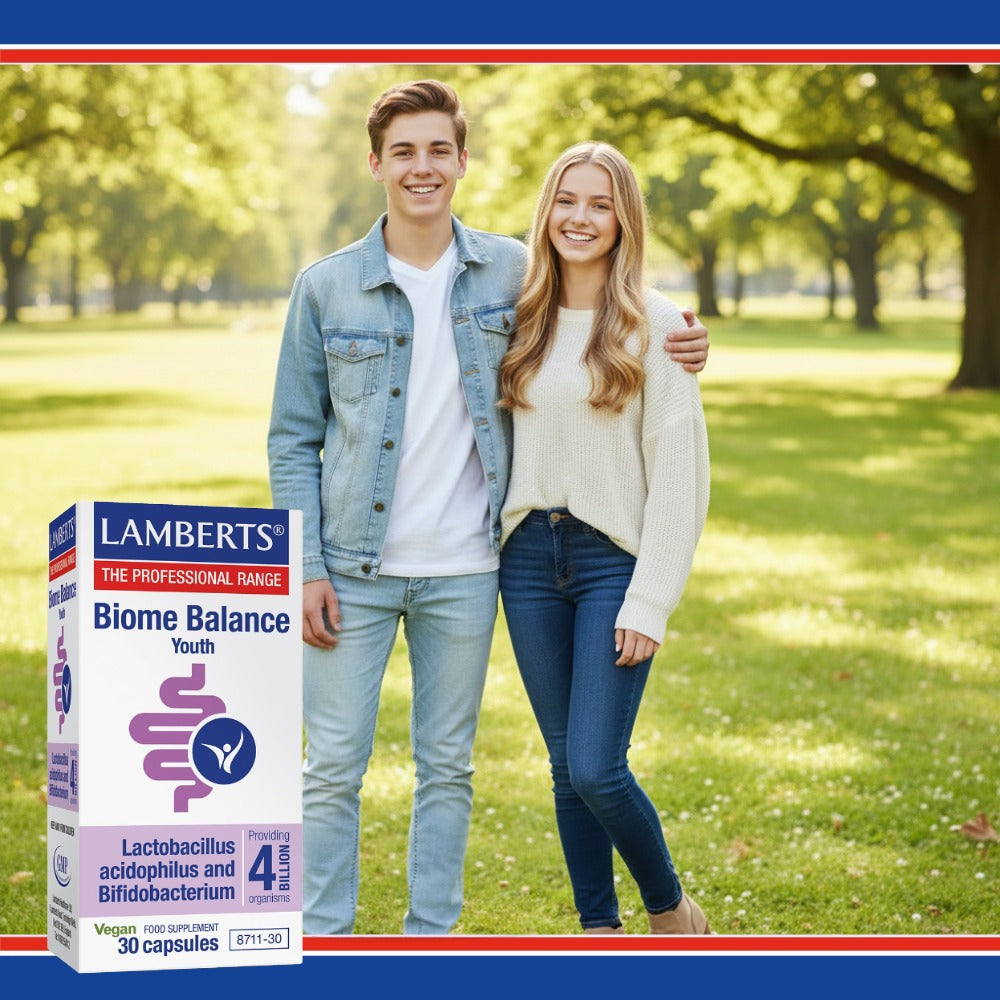 Two people standing in a park with a Lamberts Biome Balance Youth supplement box.