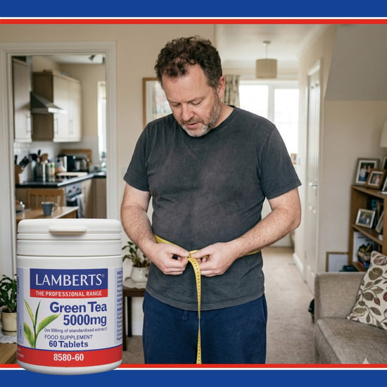 Man measuring waist with a Lamberts Green Tea 5000mg supplement container in the foreground.