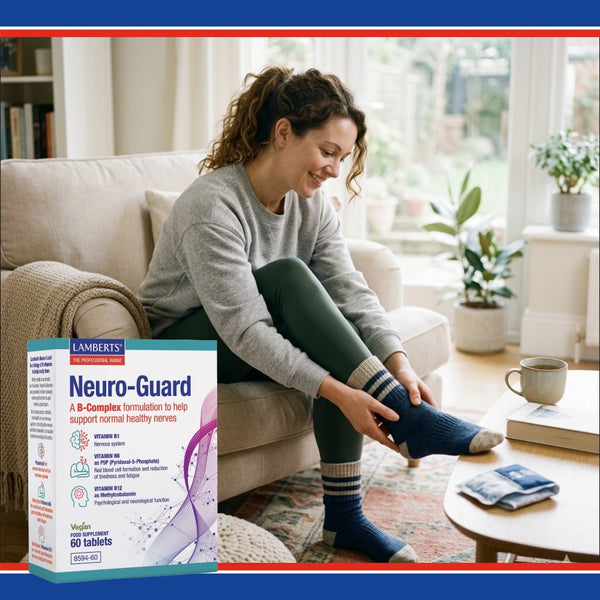Woman sitting on a couch with a box of Lamberts Neuro-Guard supplement in the foreground.