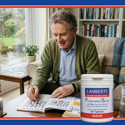 Man solving a crossword puzzle with a Lamberts supplement container in the foreground.