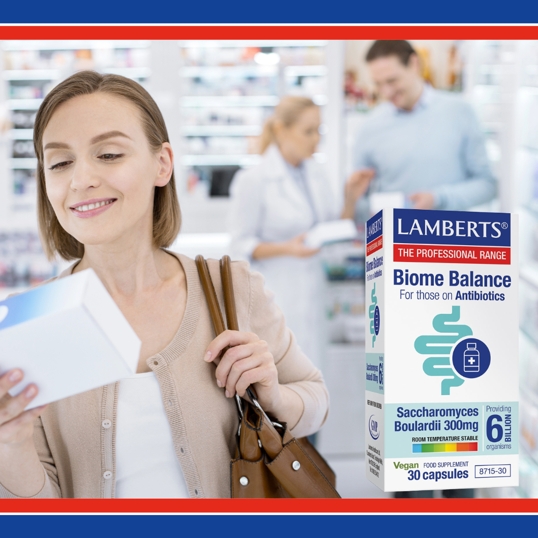 Woman holding a supplement box with 'Lambert's Biome Balance' in a pharmacy setting