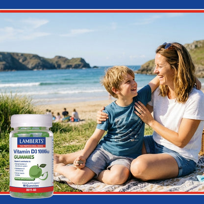 Woman and child sitting on a blanket by the beach with a bottle of Lamberts Vitamin D3 gummies.