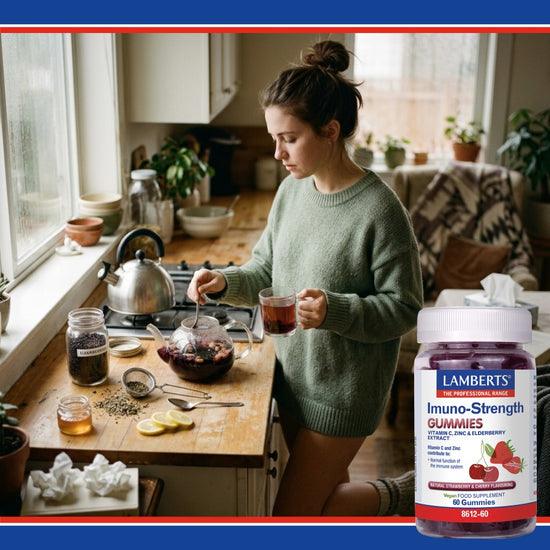 Woman in a kitchen holding a glass of tea with a bottle of Lamberts Imuno-Strength Gummies.