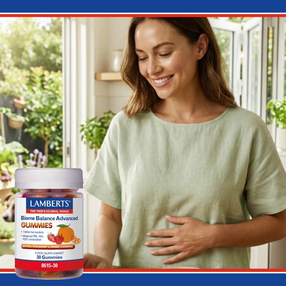 Woman standing in a bright room with a bottle of Lamberts Biome Balance Advanced Gummies.